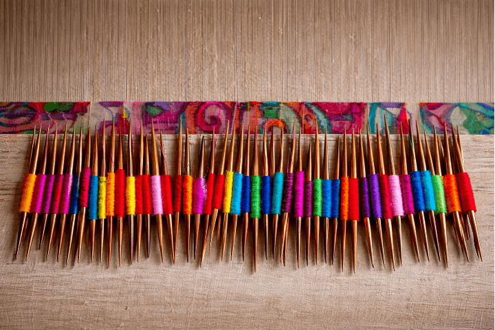 Kani Spindles — each carrying a different colored thread