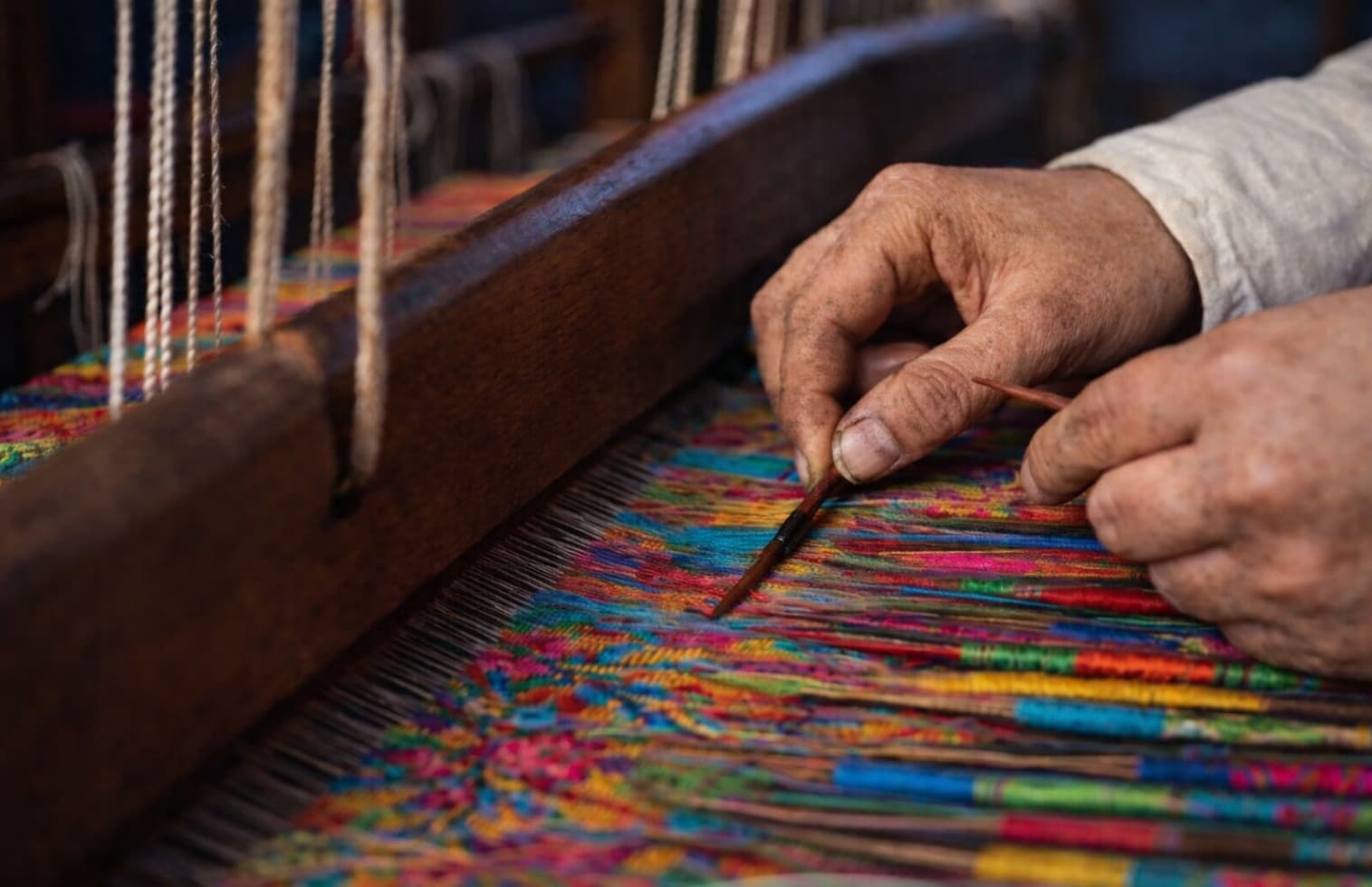 Artisan weaving a handwoven Kani shawl